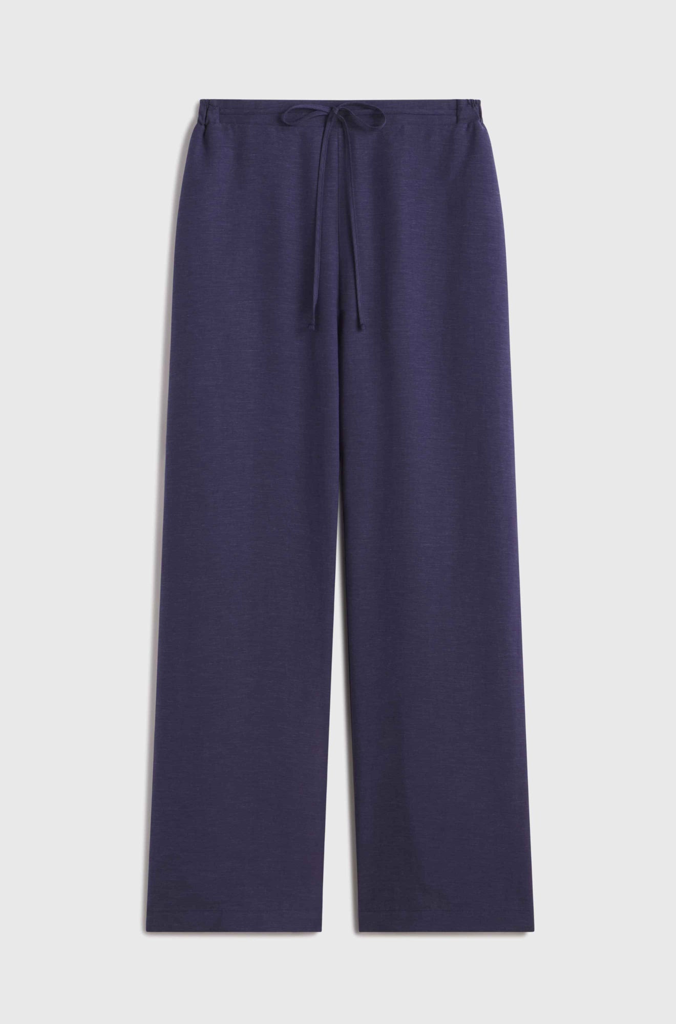 Woman wearing blue linen pants with a tie waist