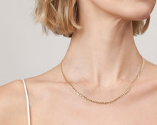 Model. Close up of woman wearing gold chain necklace