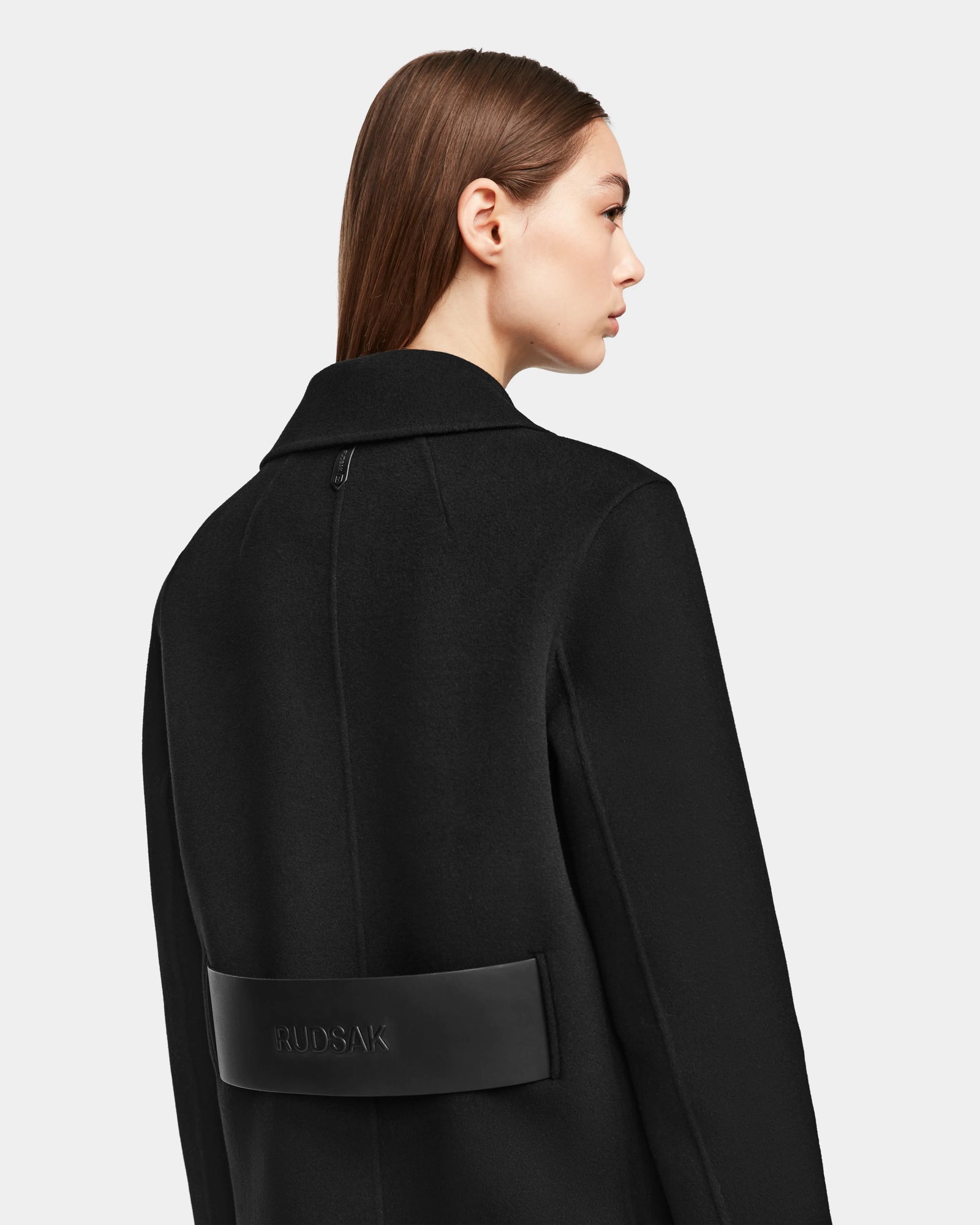 A woman wearing the LAYLAH - 8124699 Black double-breasted coat by Rudsak.