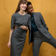 Front image of a woman wearing the horton pant in black and white houndstooth
