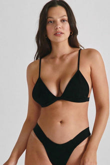 Black ribbed triangle bikini top with thin shoulder straps on model.