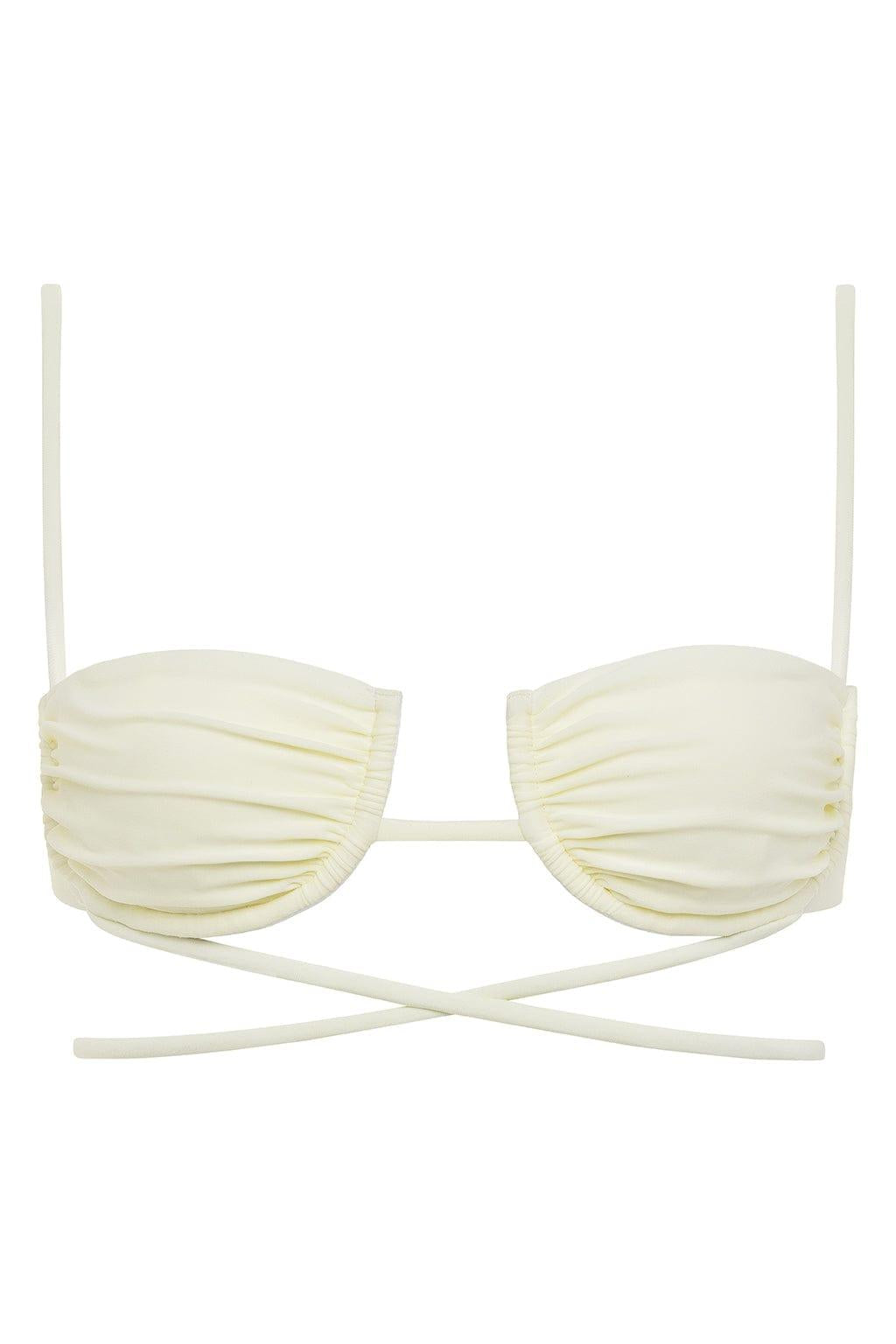 Cream bikini top with ruched cups, thin shoulder straps, and crossover back ties.