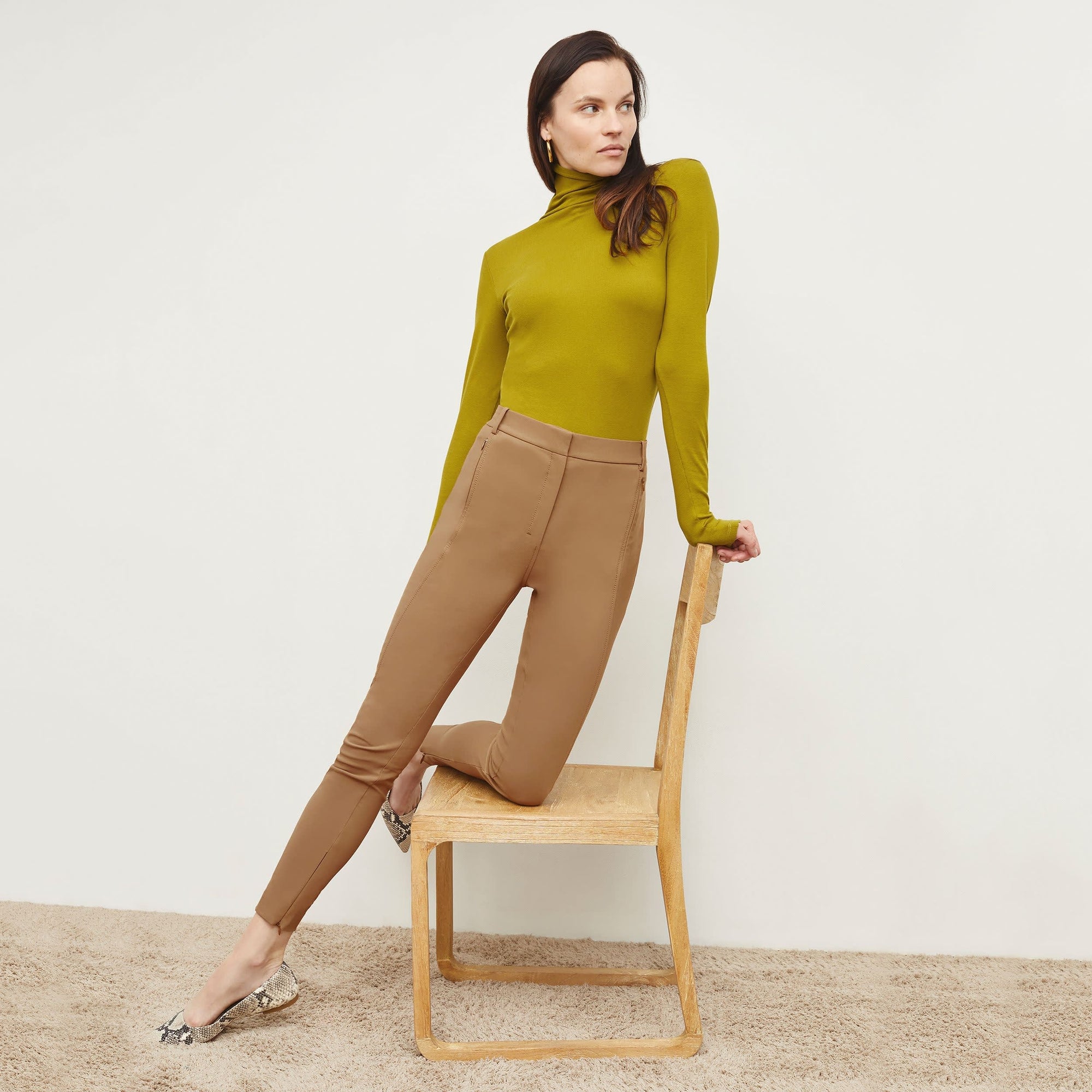 Front image of a woman standing wearing the Curie Pant—Everstretch in Saddle | Exclude