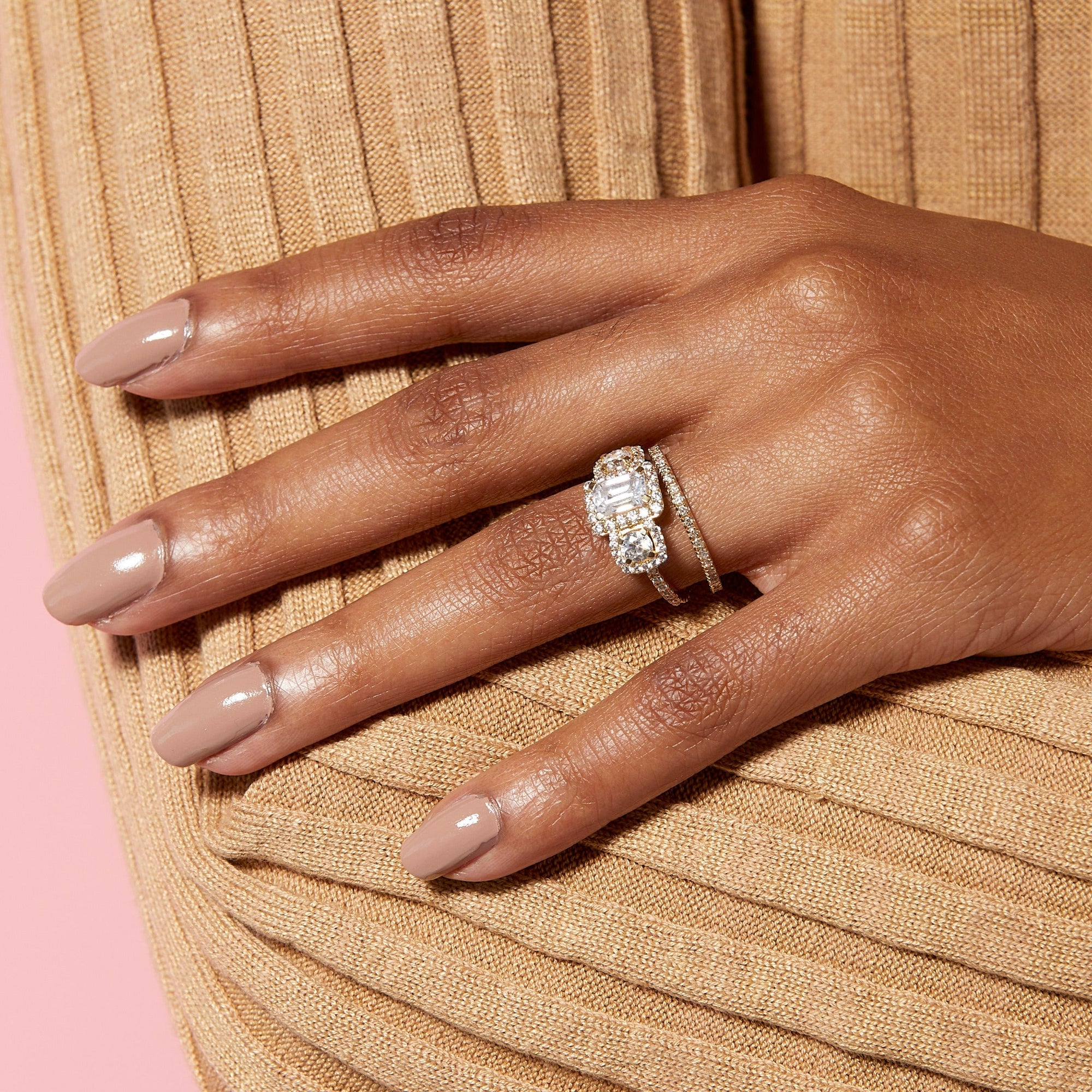Lifestyle Model. Close up of hand with large engagement ring and eternity ring