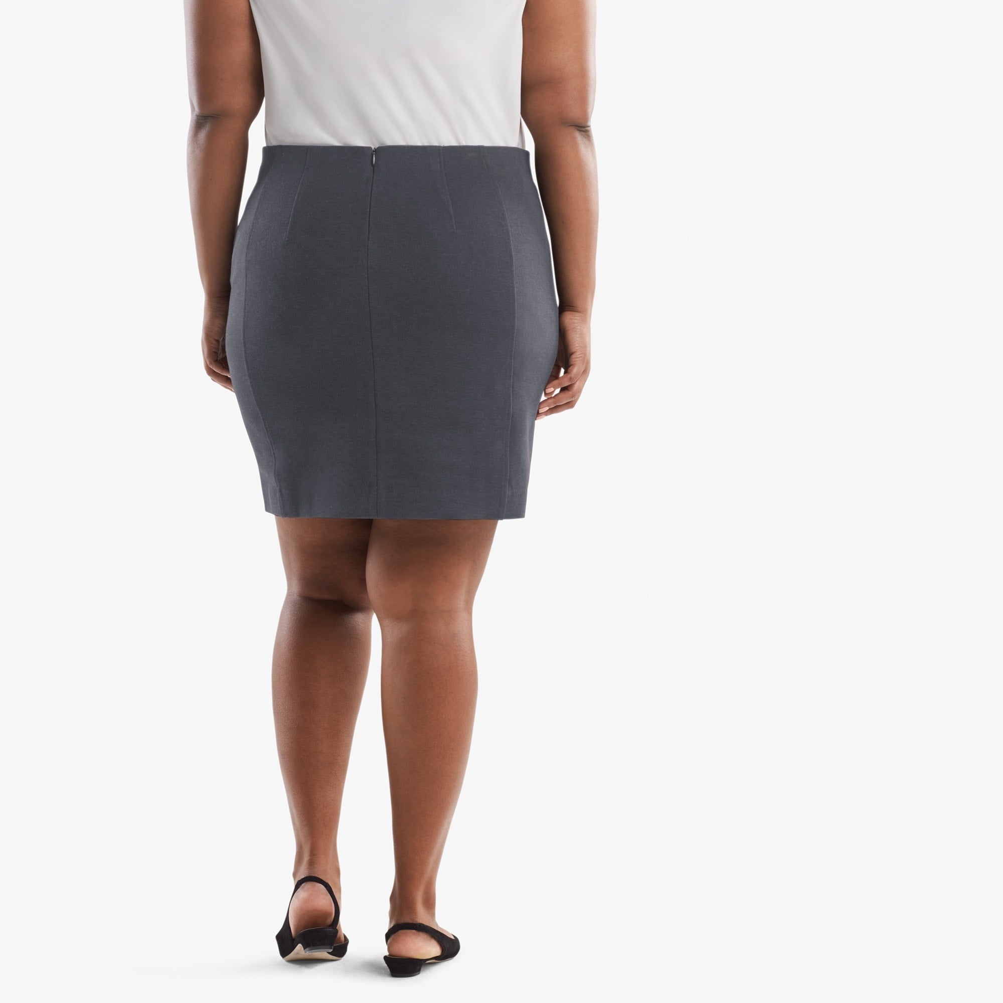 Back image of a woman standing wearing the Crosby skirt textured ponte in Charcoal | Exclude