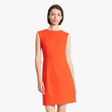 Front image of a woman standing wearing the Giovanna dress in Tangerine | Exclude