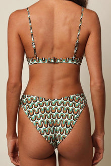 Bikini bottom with wavy zig-zag pattern in teal, orange, and cream with scalloped edges, shown from back view.