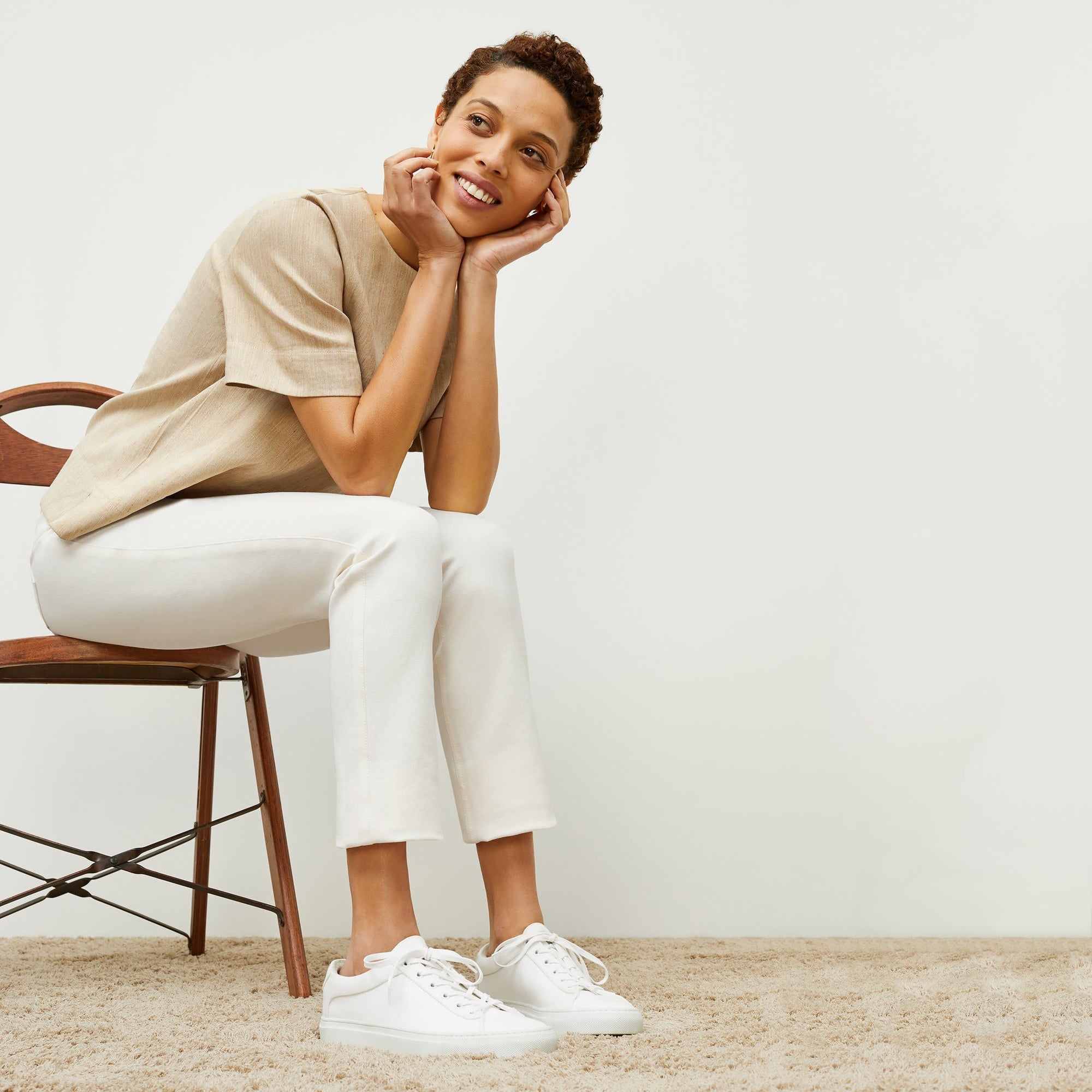 Side image of a woman sitting wearing the Hockley Jean—Better Than Denim in Tusk | Exclude