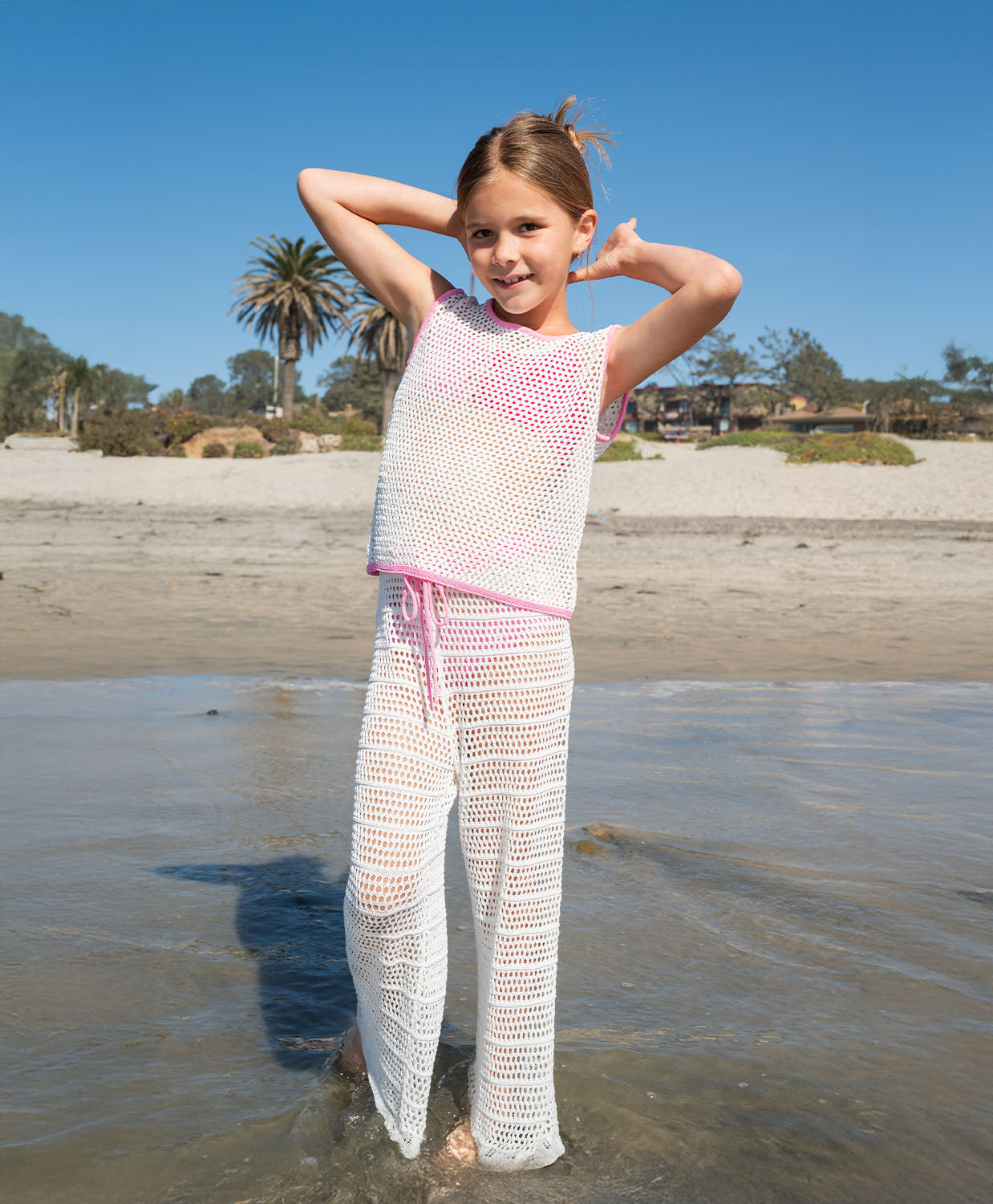 Kids White Chloe Set — a playful white crochet outfit with pink accents and a drawstring waist, perfect for sunny adventures.