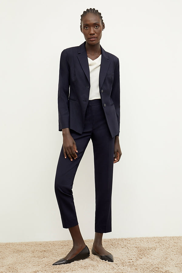 Front image of a woman standing wearing the Mejia pant in Galaxy Blue | Grid | Exclude