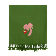 Green blanket with pink palm tree and red star design on a white background