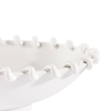 White decorative bowl with wavy rim on a white background