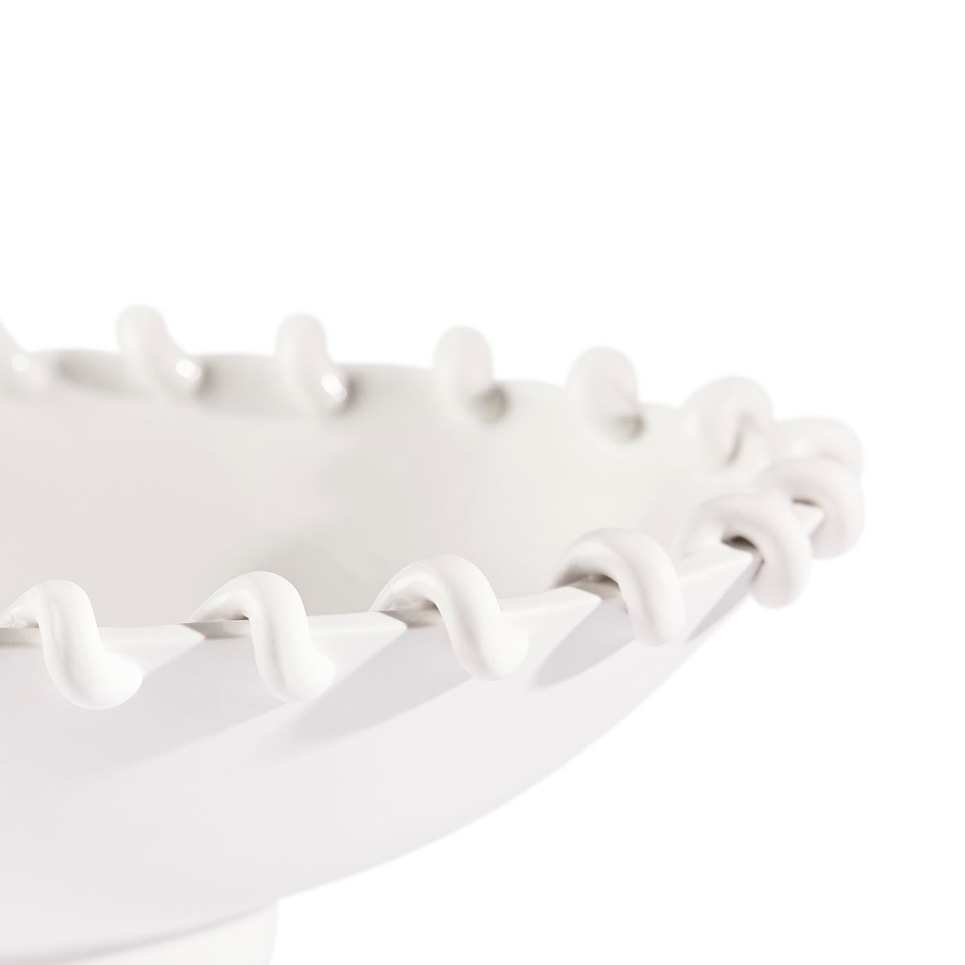 White decorative bowl with wavy rim on a white background