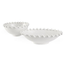 Two white ceramic bowls with textured rim on a white background