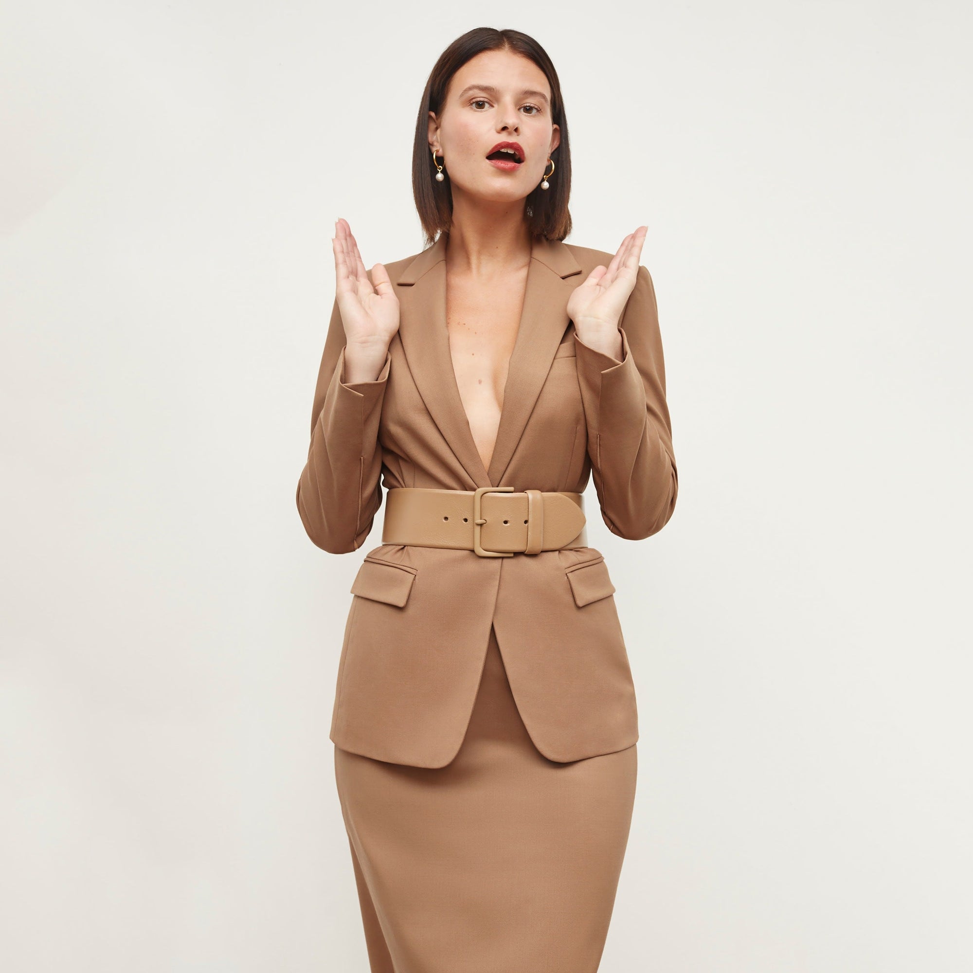 Front image of a woman standing wearing the Yiyan Blazer in Camel | Exclude