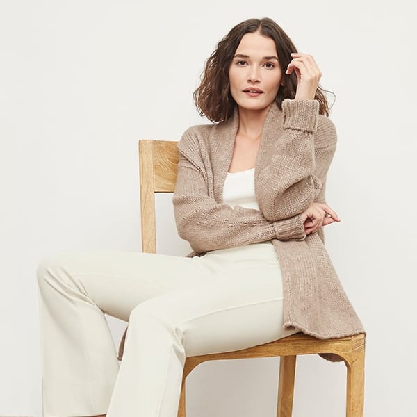 Side image of a woman standing wearing the Shiloh Pant in Pearl | Exclude