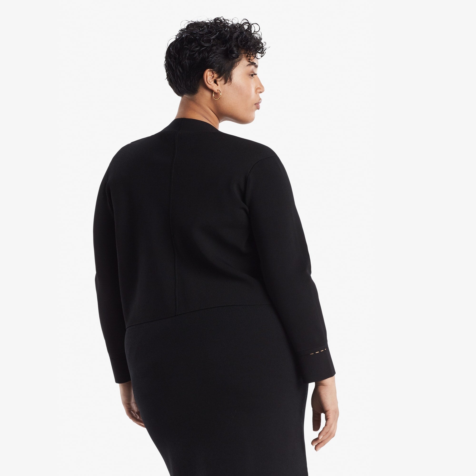 Back image of a woman standing wearing the Sant Ambroeus jardigan in black | Exclude