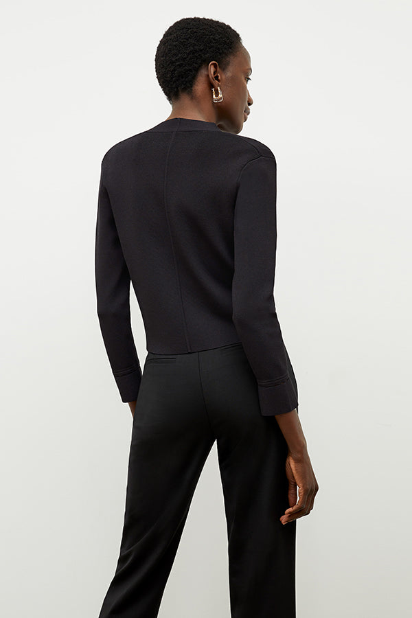 Back image of a woman standing wearing the Sant Ambroeus jardigan in black | Exclude