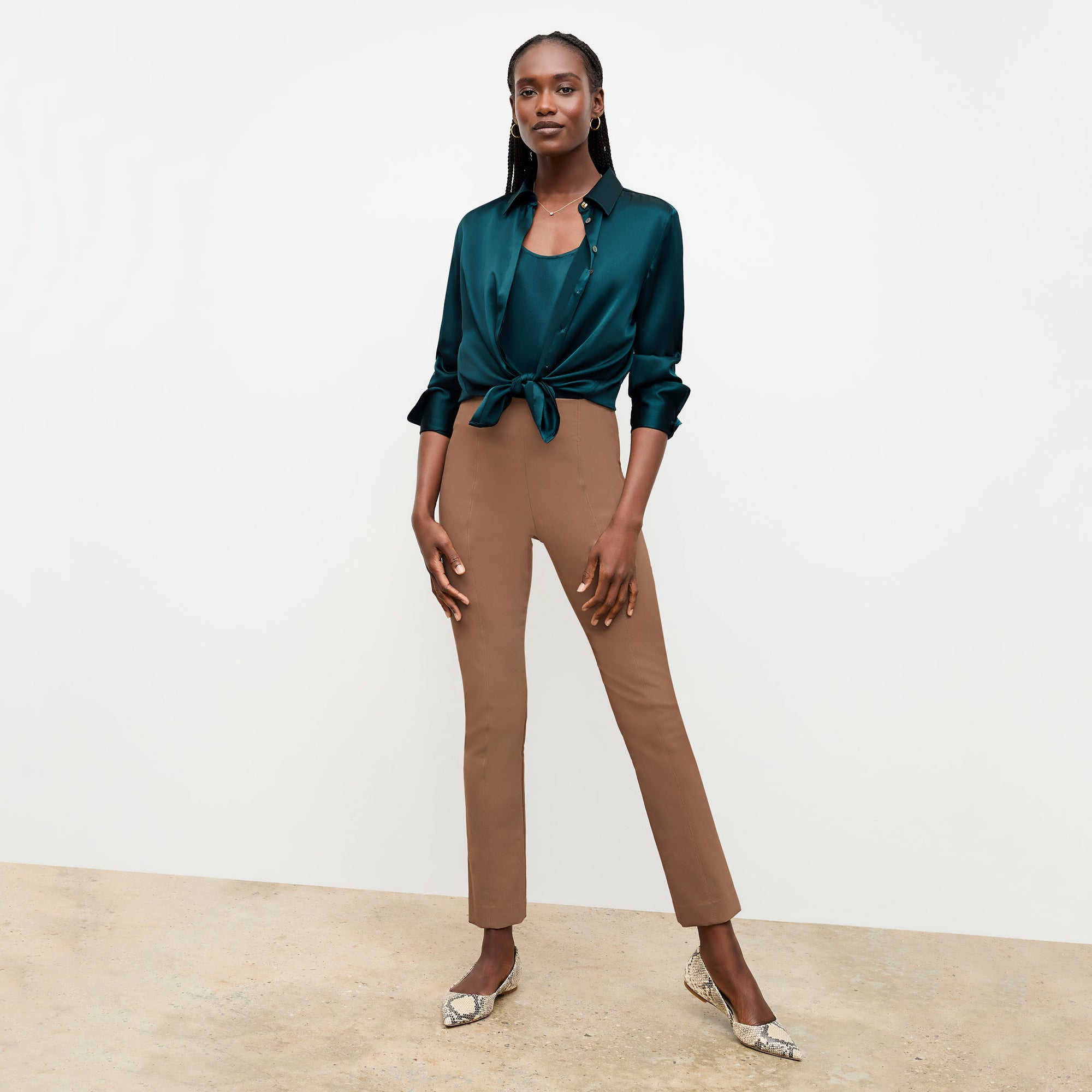 Front image of a woman sitting wearing the Foster Pant—Everstretch in Saddle