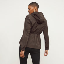 Back image of a woman standing wearing the Britt Hoodie—AirTech in Dark Moss