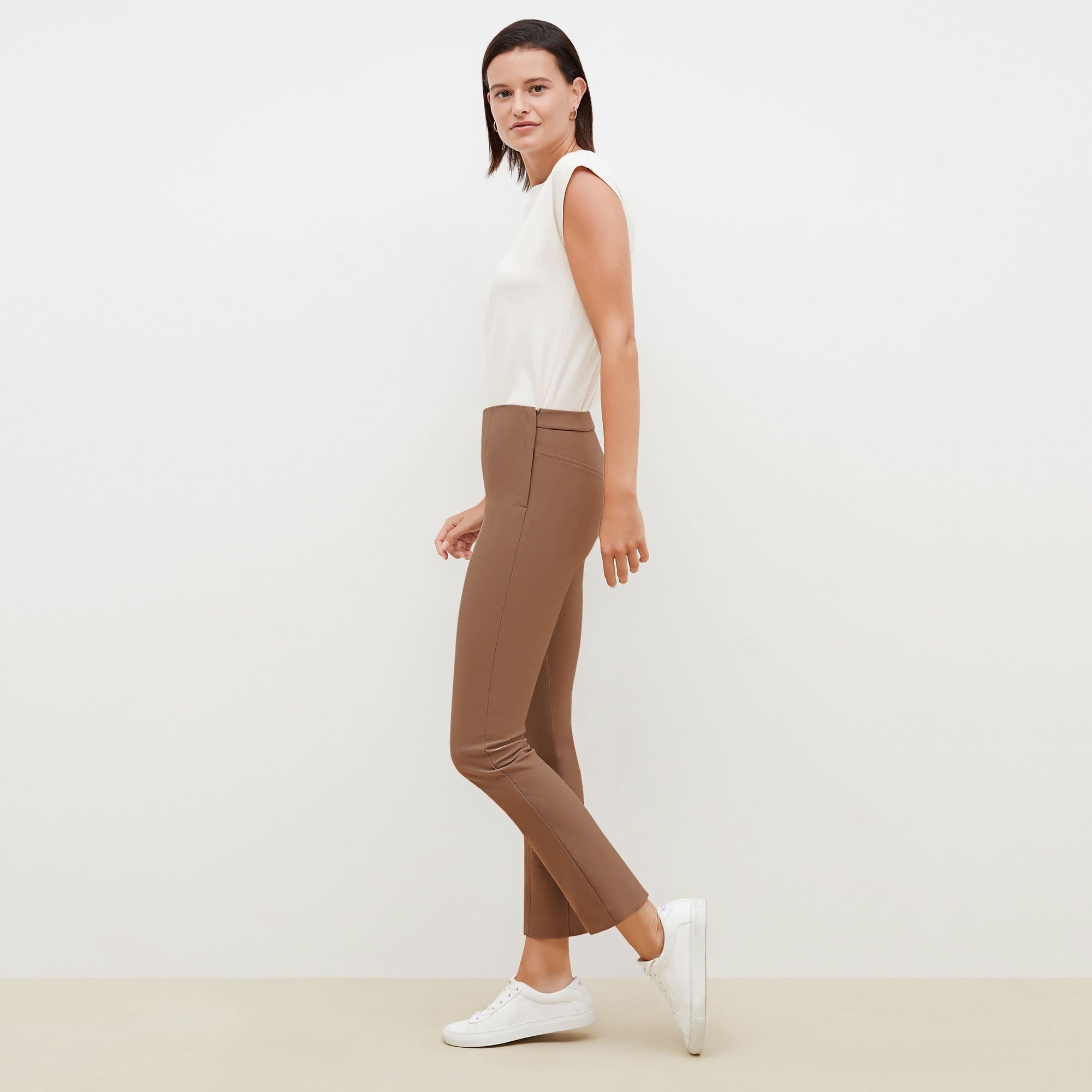 Side image of a woman standing wearing the Foster Pant—Everstretch in Saddle | Exclude
